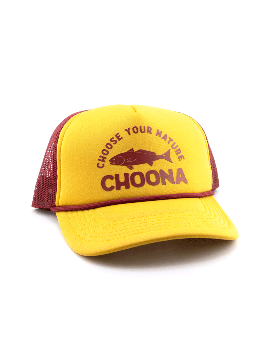 The Choona Redfish Foam Snapback is a yellow and maroon trucker hat with a mesh back and foam snapback, featuring CHOOSE YOUR NATURE CHOONA text and a maroon fish illustration on the front for a retro-meets-modern style.