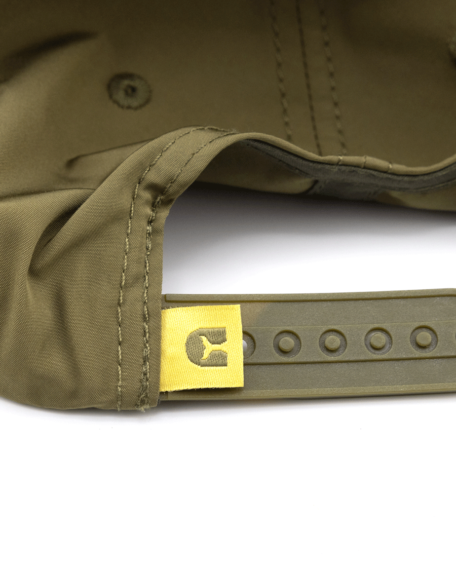Close-up of the adjustable strap on Choonas olive green Wavy Snapback, featuring a yellow fabric tag with a stylized C logo near the snap closure—ideal for any coastal adventure.