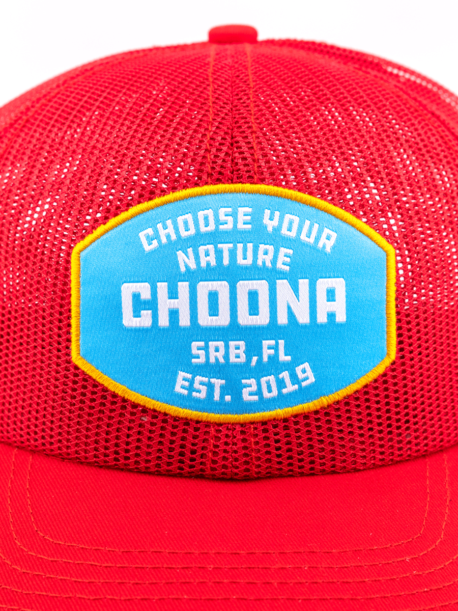 A close-up of the Breezy Snapback - Red by Choona, a mesh baseball cap with a blue and yellow patch reading CHOOSE YOUR NATURE CHOONA SRB, FL EST. 2019.