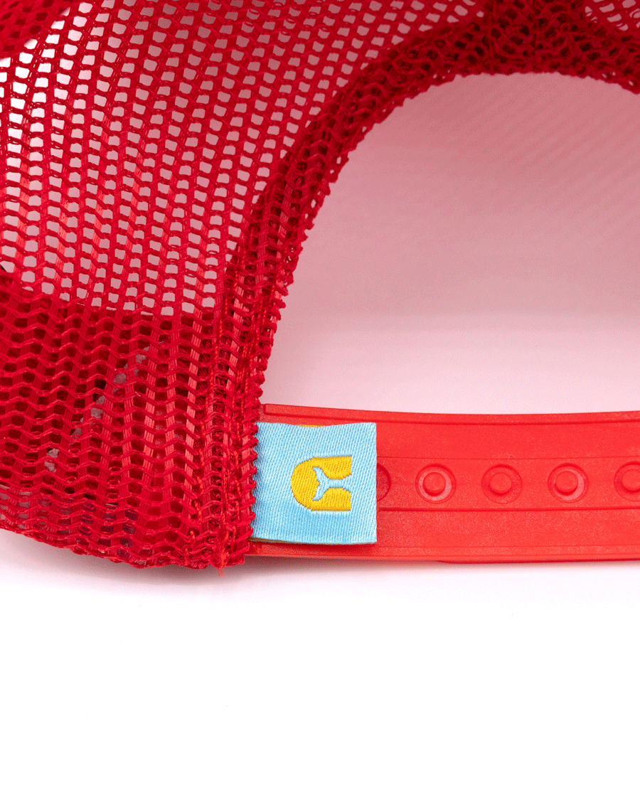Close-up of the back of Choona’s Breezy Snapback - Red, featuring a mesh body, adjustable snap closure, and a small blue tag with a yellow C sewn near the clasp.