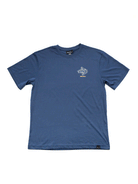 The Choona Stay Awhile Graphic Tee is a blue, short-sleeve shirt with a small white graphic and text on the left chest, made from 100% Pima Cotton—ideal for an outdoor lifestyle.