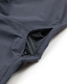 A close-up of Choonas Drifter Pant reveals an open zipper pocket lined with black fabric. The dark, smooth, slightly reflective fabric offers four-way stretch for enhanced comfort and flexibility.