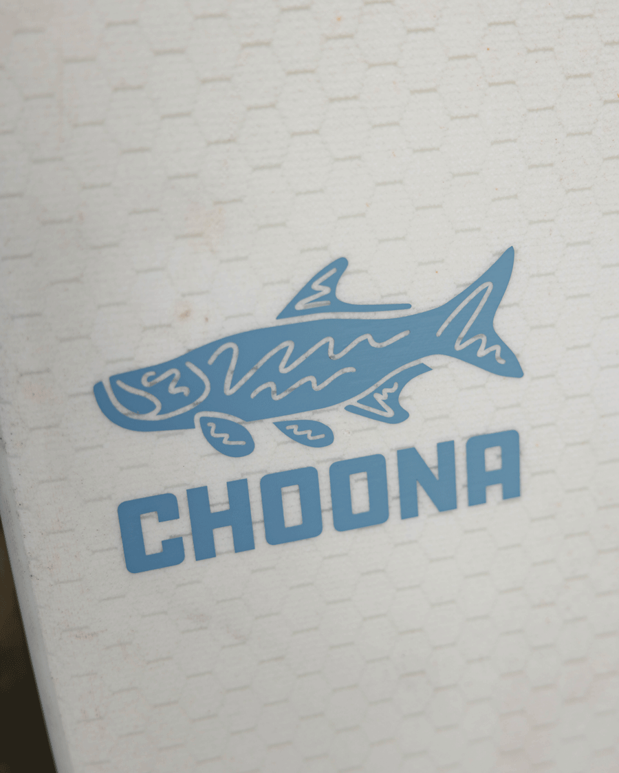A blue stylized tarpon illustration above bold blue CHOONA text on a white, hexagon-patterned background—meet the Choona Tarpon Decal by Choona, an adventure-ready sticker for those who Choose Your Nature.