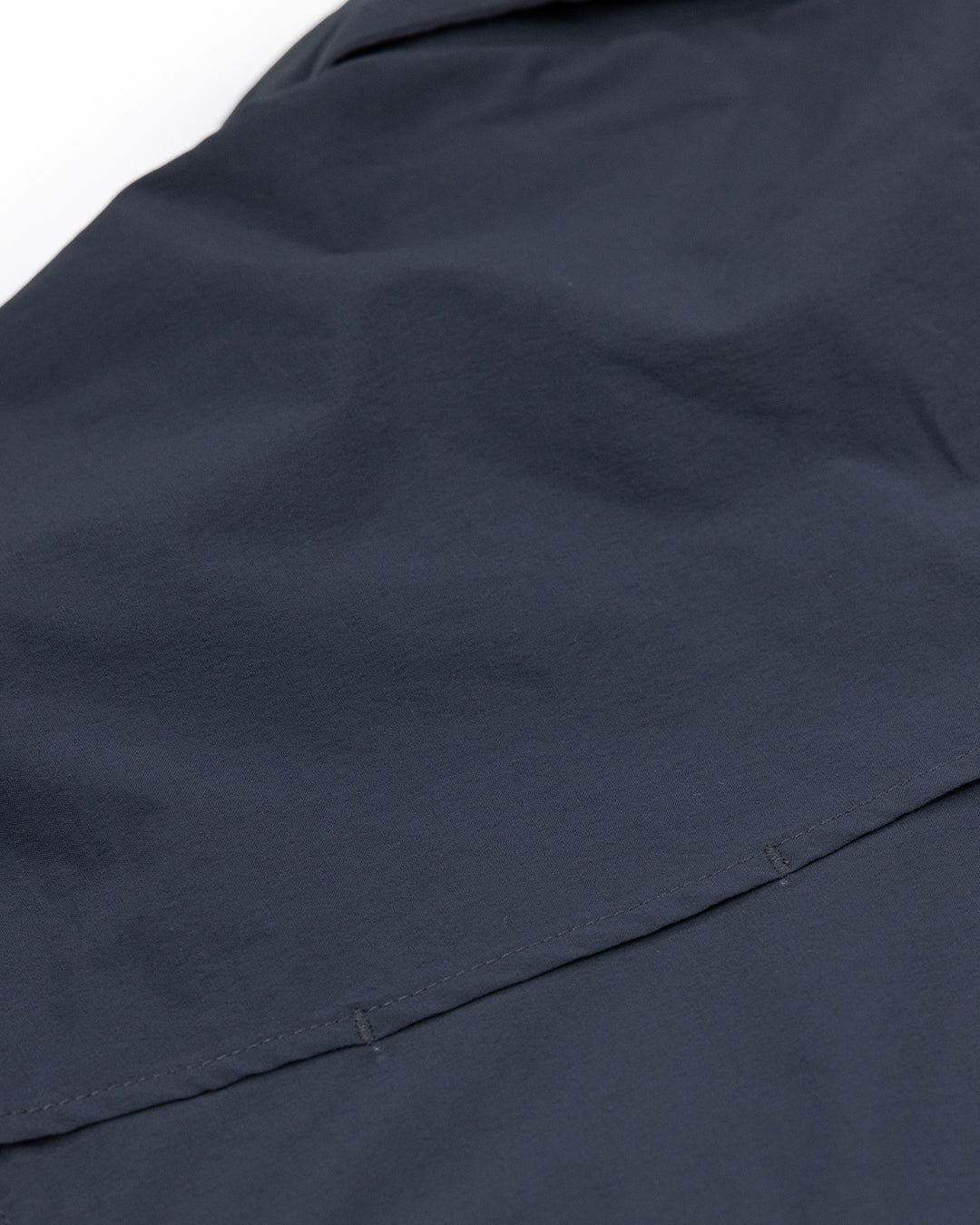 Close-up of dark navy blue fabric from the Choona Panhandle Pearl Snap, featuring a horizontal seam, smooth texture, and neat stitching—ideal for channeling coastal cowboy style inspired by the Florida Panhandle.