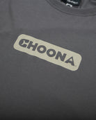 The Choona Logo Graphic Tee by Choona is a dark gray shirt made from USA-grown cotton, featuring bold, light-colored "CHOONA" lettering inside a rectangle on the chest.
